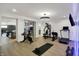 Spacious home gym featuring workout equipment, weights, and a mirrored wall at 5130 Melbourne Pl, Zionsville, IN 46077