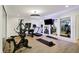 Bright home gym featuring exercise equipment and mirrored walls at 5130 Melbourne Pl, Zionsville, IN 46077