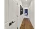 This hallway features hardwood floors and leads to a room with a comfortable chair at 5130 Melbourne Pl, Zionsville, IN 46077