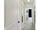 Hallway with white doors leading to rooms, showcasing modern decor and carpeted flooring at 5130 Melbourne Pl, Zionsville, IN 46077