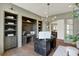 A well-appointed home office features built-in shelving, custom desk, and abundant natural light at 5130 Melbourne Pl, Zionsville, IN 46077