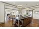 Gourmet kitchen features a large island with sink, open shelving, and easy access to the dining room at 5130 Melbourne Pl, Zionsville, IN 46077
