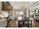 Open concept kitchen with large island, stainless steel range, and access to outdoor dining and entertaining spaces at 5130 Melbourne Pl, Zionsville, IN 46077