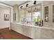 Bright and modern kitchen with a window above the sink, marble countertops, and stainless steel appliances at 5130 Melbourne Pl, Zionsville, IN 46077