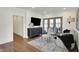 Cozy living room with stylish seating, a modern credenza and french doors to another room at 5130 Melbourne Pl, Zionsville, IN 46077