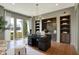 Well-lit home office with built-in cabinets and expansive windows offers a productive workspace at 5130 Melbourne Pl, Zionsville, IN 46077