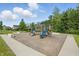 A playground with a climbing area and slides in a well maintained common area at 5130 Melbourne Pl, Zionsville, IN 46077