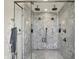 This walk-in shower features dual shower heads, marble tiling, and glass surround at 5130 Melbourne Pl, Zionsville, IN 46077