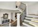 Elegant staircase with dark metal railings and light wood steps adds a touch of sophistication to the home at 5130 Melbourne Pl, Zionsville, IN 46077