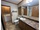 Bathroom featuring a vanity, toilet, and doorway to the laundry area, offering practicality and style at 529 E Jackson St, Martinsville, IN 46151