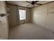 Empty bedroom showing the neutral walls, carpet, ceiling fan, and window at 529 E Jackson St, Martinsville, IN 46151