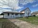A charming home with a covered front porch, brick-paved walkway, and manicured lawn presents a welcoming facade at 529 E Jackson St, Martinsville, IN 46151