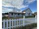 Charming two story home featuring a covered porch, white picket fence, and a classic architectural style at 529 E Jackson St, Martinsville, IN 46151