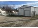 Property with large metal building on a gravel drive, adjacent to main house with white picket fence at 529 E Jackson St, Martinsville, IN 46151