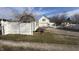 Property with white fencing, mature trees and gravel driveway, and house with attached garage at 529 E Jackson St, Martinsville, IN 46151