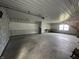 Spacious garage interior with large open floorplan, high ceiling and access to second story at 529 E Jackson St, Martinsville, IN 46151