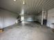 Spacious garage interior with large open floorplan and side service entry door at 529 E Jackson St, Martinsville, IN 46151