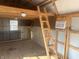 Spacious garage interior with ladder to loft space, and window for natural lighting at 529 E Jackson St, Martinsville, IN 46151