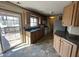 Bright kitchen with wood cabinets, sliding door to deck, and a sink area with a window at 529 E Jackson St, Martinsville, IN 46151