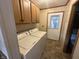 Functional laundry room equipped with washer, dryer, and cabinet space for added convenience at 529 E Jackson St, Martinsville, IN 46151
