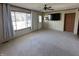Bright living room features neutral carpet, ceiling fan, and large window for a warm and inviting atmosphere at 529 E Jackson St, Martinsville, IN 46151