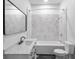 Elegant bathroom features marble tile, sleek black fixtures, and a modern design at 555 N Hamilton Ave, Indianapolis, IN 46201