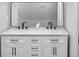 Bathroom vanity with double sinks, black faucets, and a decorative mirror at 555 N Hamilton Ave, Indianapolis, IN 46201