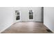 Bright bedroom boasts neutral walls, light wood floors, and natural light from two windows at 555 N Hamilton Ave, Indianapolis, IN 46201