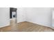 Fresh bedroom features a doorway and window, with light hardwood flooring at 555 N Hamilton Ave, Indianapolis, IN 46201