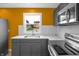 This kitchen features stainless steel appliances, quartz countertops, and modern backsplash at 555 N Hamilton Ave, Indianapolis, IN 46201
