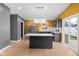 This kitchen features stainless steel appliances, an island, modern backsplash, and a statement light fixture at 555 N Hamilton Ave, Indianapolis, IN 46201