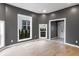 Living room with hardwood floors, modern gray walls, a view of the outdoors, and stylish decor at 555 N Hamilton Ave, Indianapolis, IN 46201