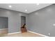 This living room features hardwood floors, gray walls, recessed lights, and a staircase at 555 N Hamilton Ave, Indianapolis, IN 46201