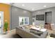 This living room features a gray couch, hardwood floors, recessed lights, and a TV at 555 N Hamilton Ave, Indianapolis, IN 46201