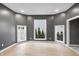 Bright living room with hardwood floors, modern gray walls, and a view of the outdoors at 555 N Hamilton Ave, Indianapolis, IN 46201