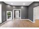 Bright living room with hardwood floors, modern gray walls, and a view of the outdoors at 555 N Hamilton Ave, Indianapolis, IN 46201