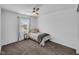 Bright bedroom with a ceiling fan, large window, and neutral colored carpet at 5788 Terracotta Trce, McCordsville, IN 46055