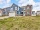 Charming two-story home with blue and brick facade, attached garage, and well-maintained front lawn at 5788 Terracotta Trce, McCordsville, IN 46055