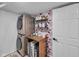Functional laundry room with stackable washer and dryer and stylish floral wallpaper at 5788 Terracotta Trce, McCordsville, IN 46055
