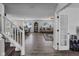 Open concept living area featuring hardwood floors, a dining area, and a cozy seating arrangement at 5788 Terracotta Trce, McCordsville, IN 46055