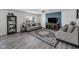 Comfortable living room with a plush sofa, stylish rug, and a modern entertainment center at 5788 Terracotta Trce, McCordsville, IN 46055