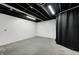 Finished basement features concrete floors, a black ceiling and white walls at 6036 Terrytown Pkwy, Indianapolis, IN 46254