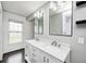 Updated bathroom with double sinks, granite countertops, and natural light at 6036 Terrytown Pkwy, Indianapolis, IN 46254