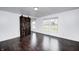 Spacious bedroom with hardwood floors, large windows, and rustic barn door at 6036 Terrytown Pkwy, Indianapolis, IN 46254