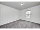 Bedroom featuring neutral walls, gray carpeting, and a window for natural light at 6036 Terrytown Pkwy, Indianapolis, IN 46254