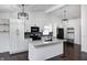 Modern kitchen featuring white cabinets, a large island, and stainless steel appliances at 6036 Terrytown Pkwy, Indianapolis, IN 46254