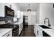 Updated kitchen with black stainless appliances, marble countertops, and subway tile backsplash at 6036 Terrytown Pkwy, Indianapolis, IN 46254