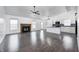 Spacious living room featuring dark wood floors, a ceiling fan, and a cozy fireplace at 6036 Terrytown Pkwy, Indianapolis, IN 46254