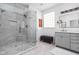 Spa-like bathroom with glass enclosed shower, marble tile, modern vanity, and ample lighting at 634 N Senate Ave, Indianapolis, IN 46202