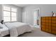 Light bedroom with a window, and a mid-century modern dresser with several drawers and a door to the bathroom at 634 N Senate Ave, Indianapolis, IN 46202